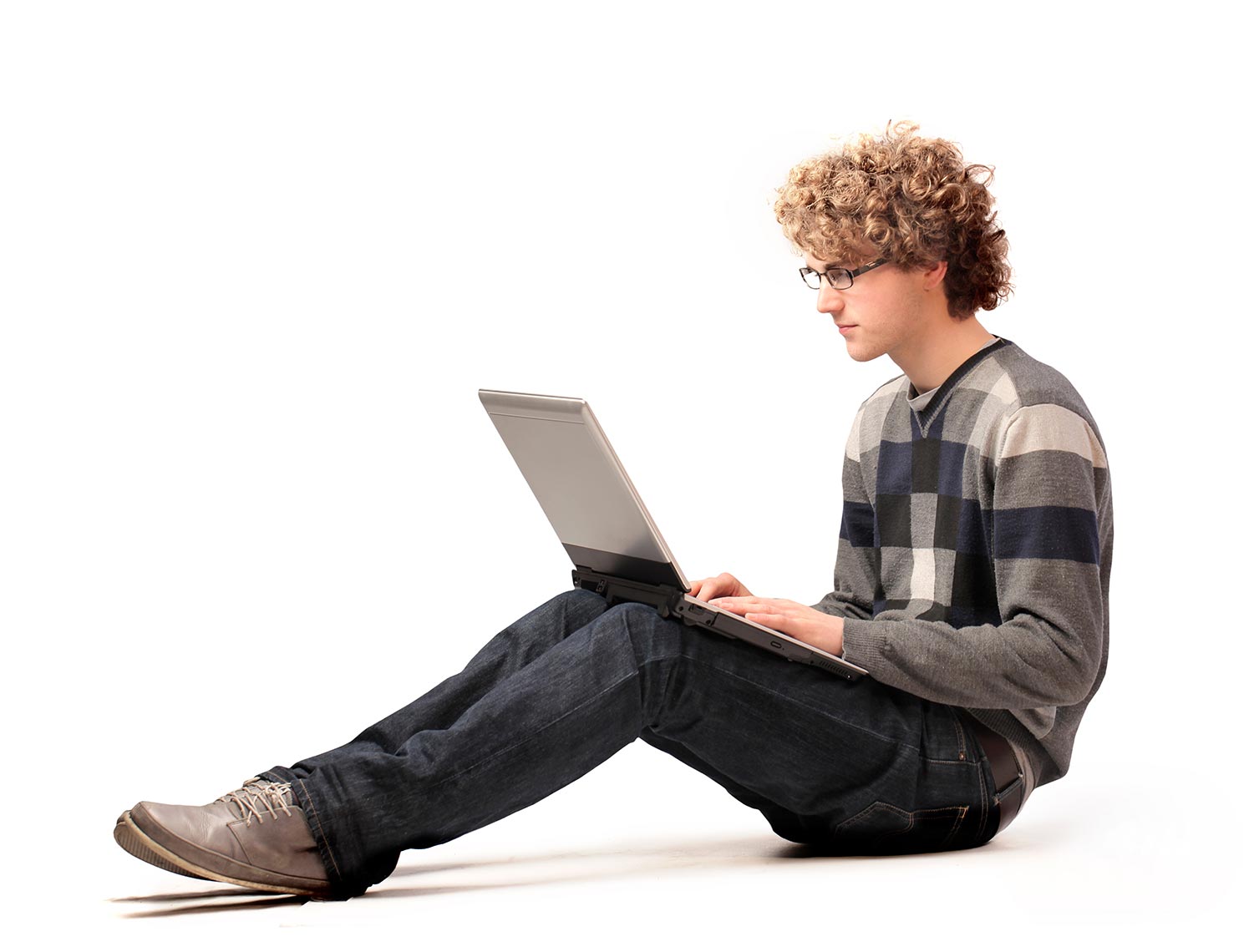young man sitting on floor with laptop on his knees depicting browsing Get Resume Help packages